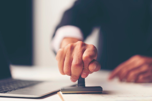 Hand stamping a business document