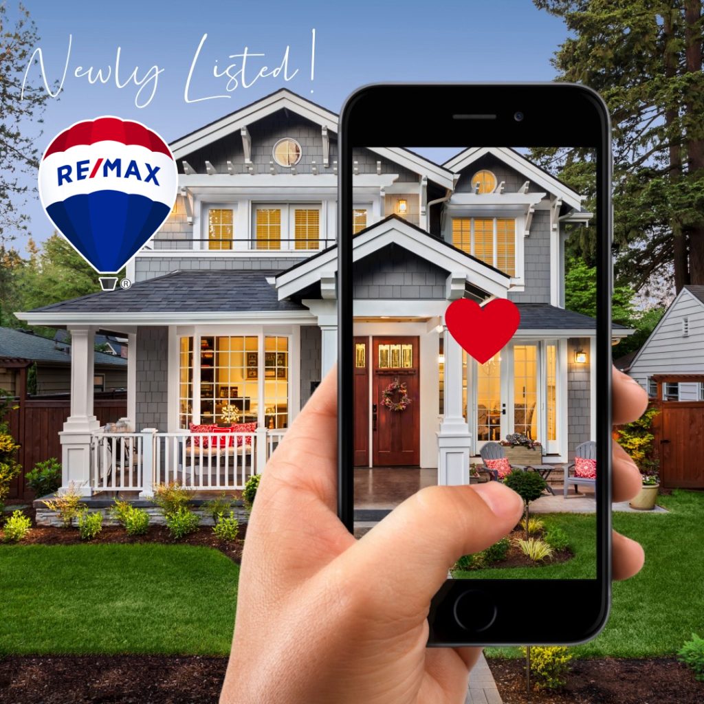 RE/MAX listing with a cell phone